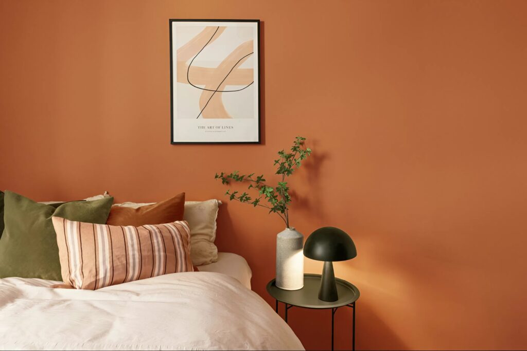 Cozy bedroom painted in warm fall tones by an interior painter in Old Colorado City, CO