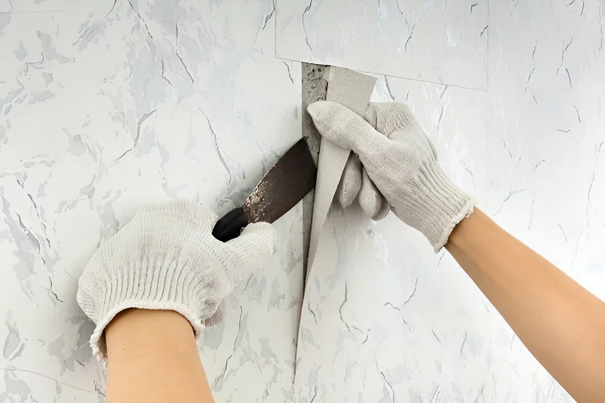 Wallpaper being removed by a house painter in Cedar Heights, CO