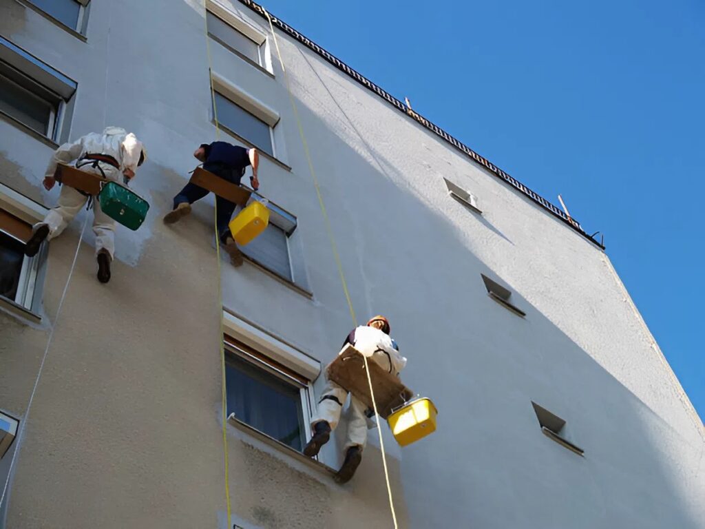 Commercial painters repainting a multi-story building exterior in Old Colorado City, CO
